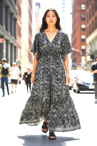 Woman in a Les Sûtras Muti-colour - Silk Viscose Dress - Blue Grey dress walking on a city street
